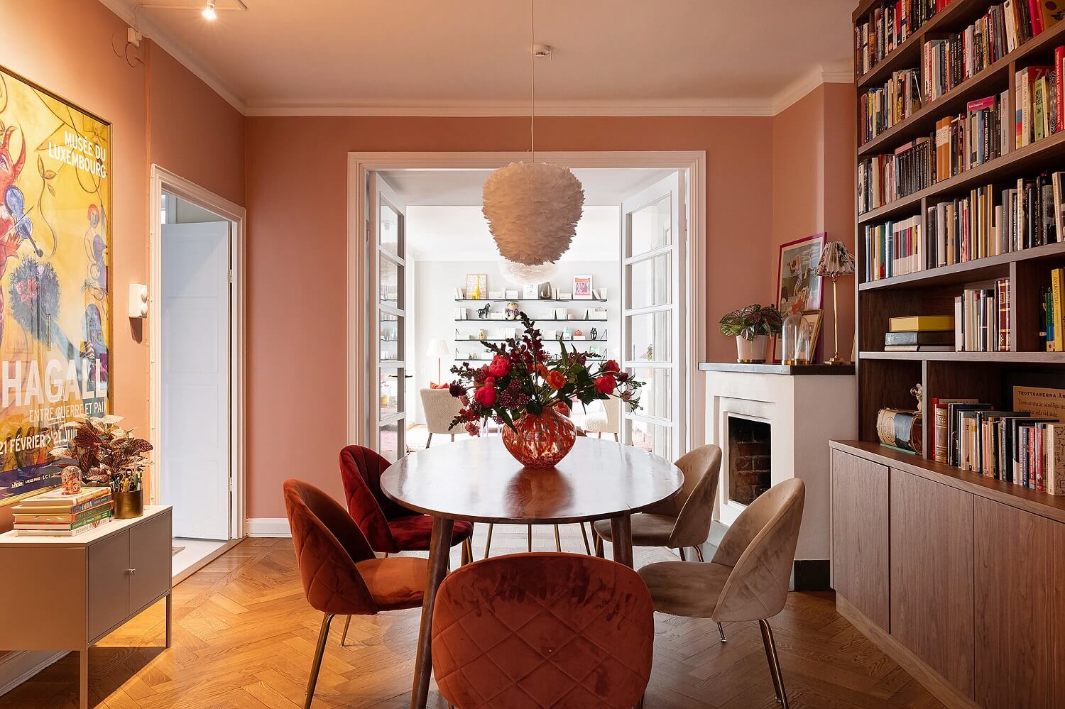 A Serene Nordic Apartment with Pink Color Accents 12 dining-room-velvet-chairs-bookcase-earthy-pink-walls-nordroom