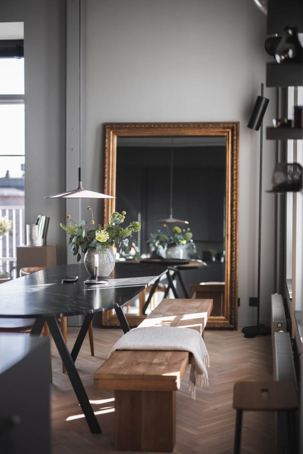 A Modern Gray Industrial Apartment 2 dining-table-wooden-bench-large-gold-mirror-nordroom