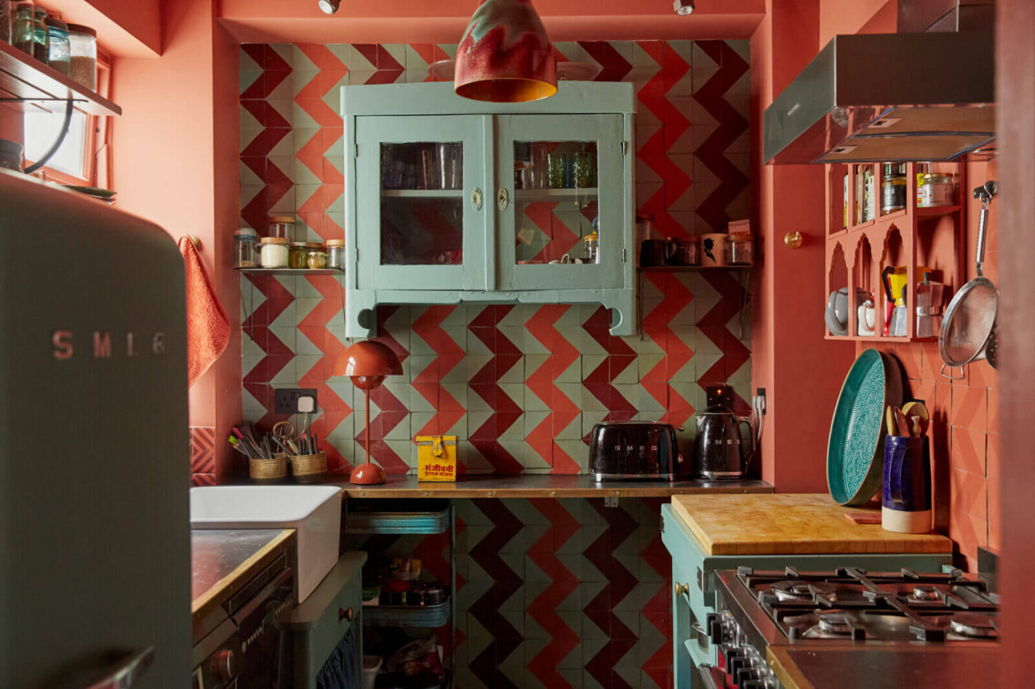 Jewel-Toned Hues in a Vibrant Eclectic Mews House 8 galley-kitchen-edward-bulmer-red-ochre-jaggery-hand-painted-tiles-nordroom