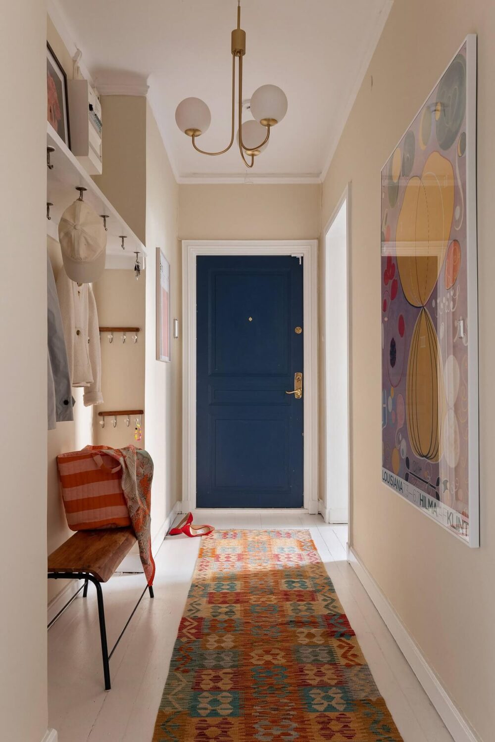 A Serene Nordic Apartment with Pink Color Accents 22 hallway-beige-walls-niche-coat-storage-bench-runner-nordroom