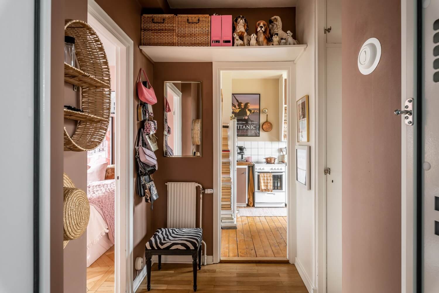 A Pink Studio Apartment with a Midcentury Kitchen 9 hallway-brown-pink-walls-shelf-above-door-nordroom