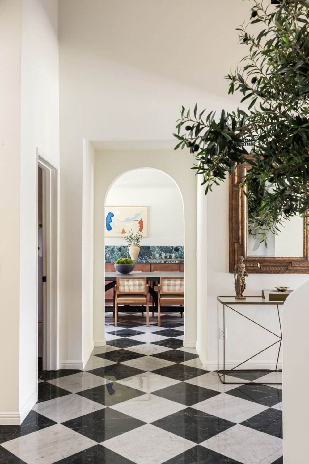 A Beautiful Serene Home in Encino Hills 11 hallway-checkerboard-floor-tiles-arched-doorway-nordroom
