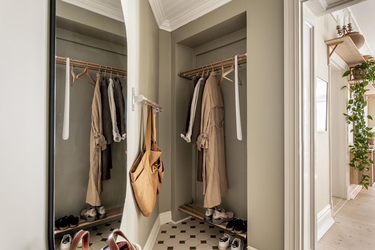A Scandinavian Apartment with a Pale Yellow Kitchen 21 halway-gray-walls-built-in-coat-storage-nordroom