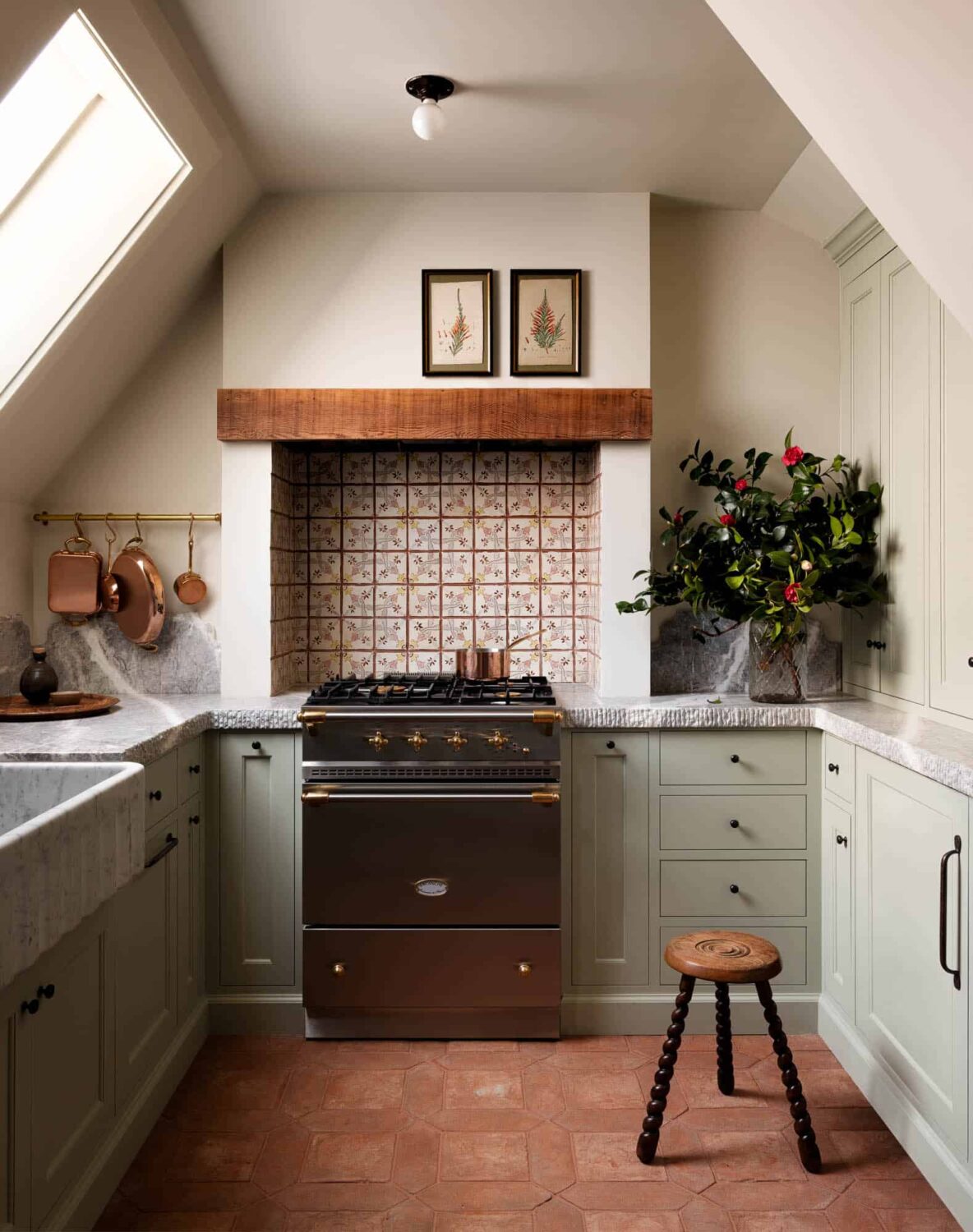 A Cozy Pied-à-Terre with Slanted Ceilings and Wallpaper 7 kitchen-light-green-cabinets-terracotta-floor-tiles-slanted-ceilings-nordroom