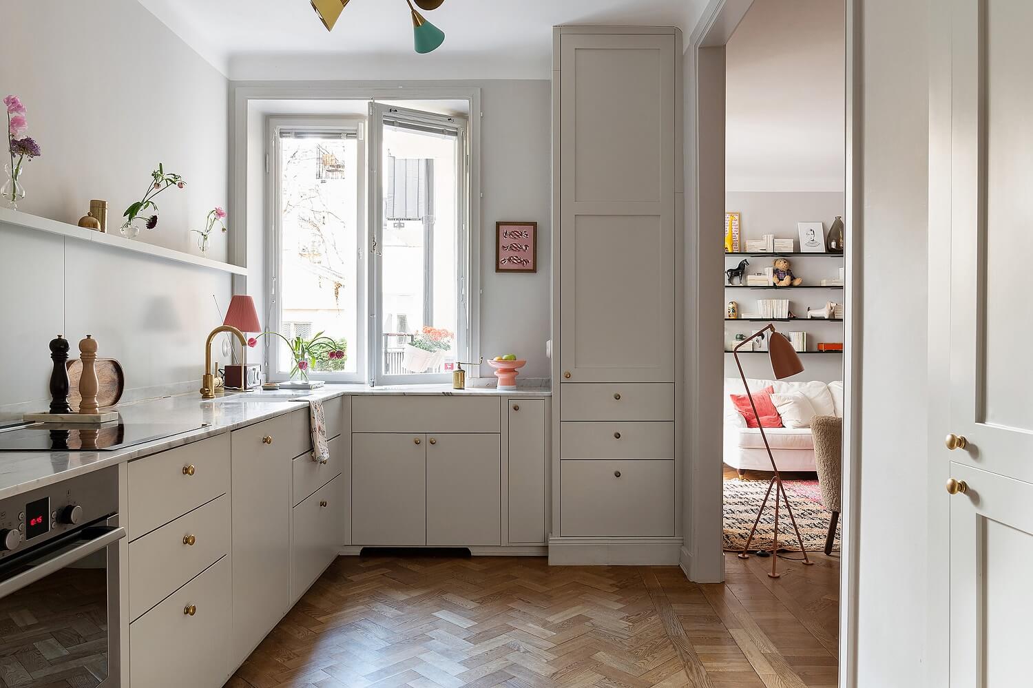 A Serene Nordic Apartment with Pink Color Accents 5 kitchen-scandinavian-design-gray-cabinets-wooden-floor-nordroom
