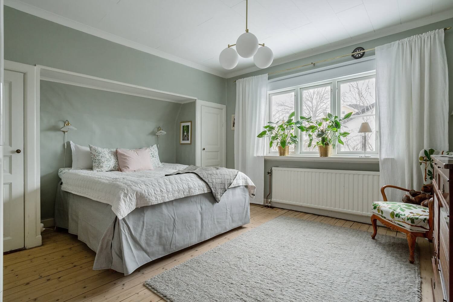 Green Tones and Wallpaper in a Charming Swedish Home 12 master-bedroom-light-green-walls-built-in-wardrobes-nordroom