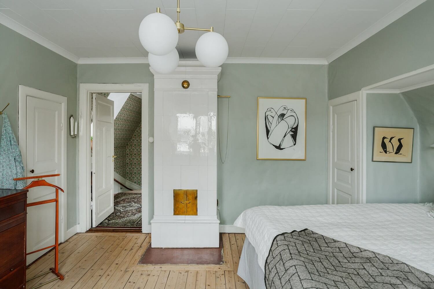 Green Tones and Wallpaper in a Charming Swedish Home 15 master-bedroom-light-green-walls-tiled-fireplace-nordroom