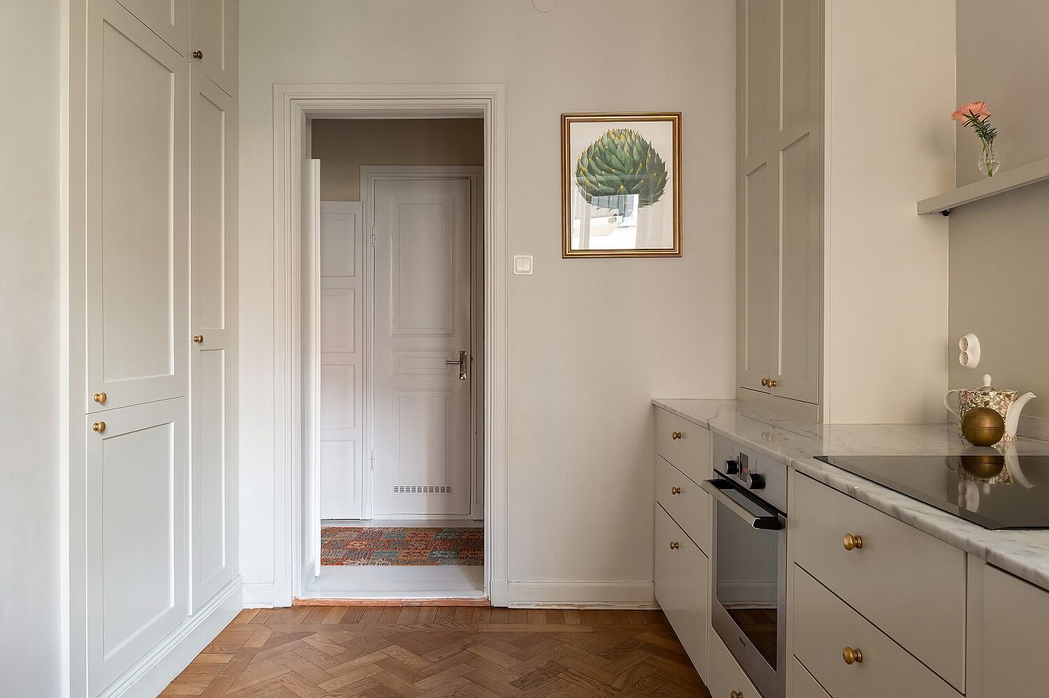 A Serene Nordic Apartment with Pink Color Accents 9 minimalistic-gray-kitchen-wooden-floor-nordroom