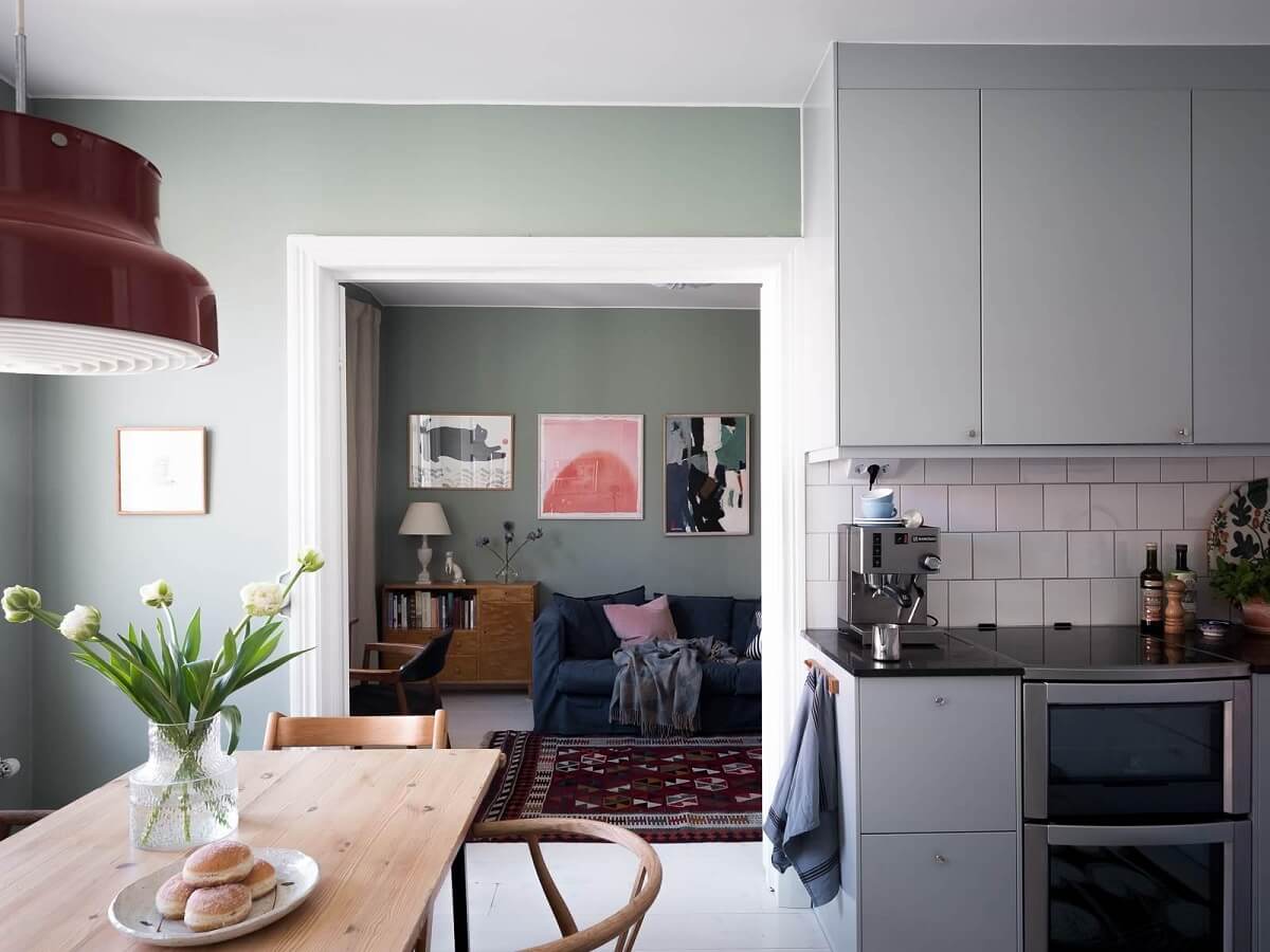 A Scandinavian Duplex That Blends Old and New 11 modern-kitchen-dining-table-blue-gray-cabinets-nordroom