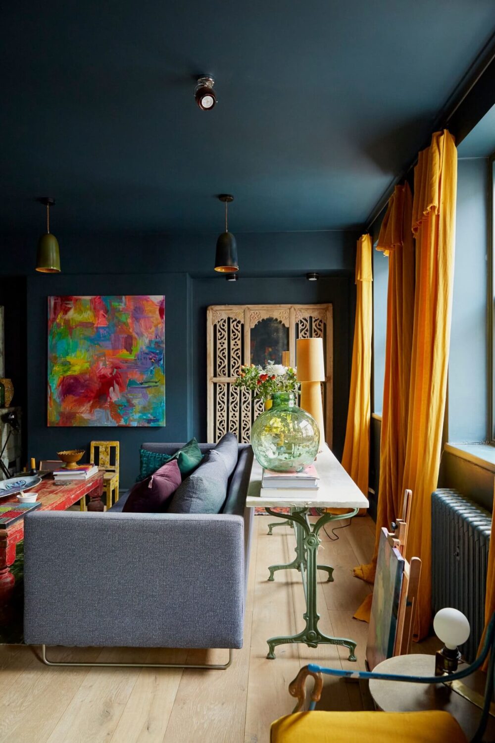 Jewel-Toned Hues in a Vibrant Eclectic Mews House 2 moody-blue-living-room-yellow-color-accents-nordroom