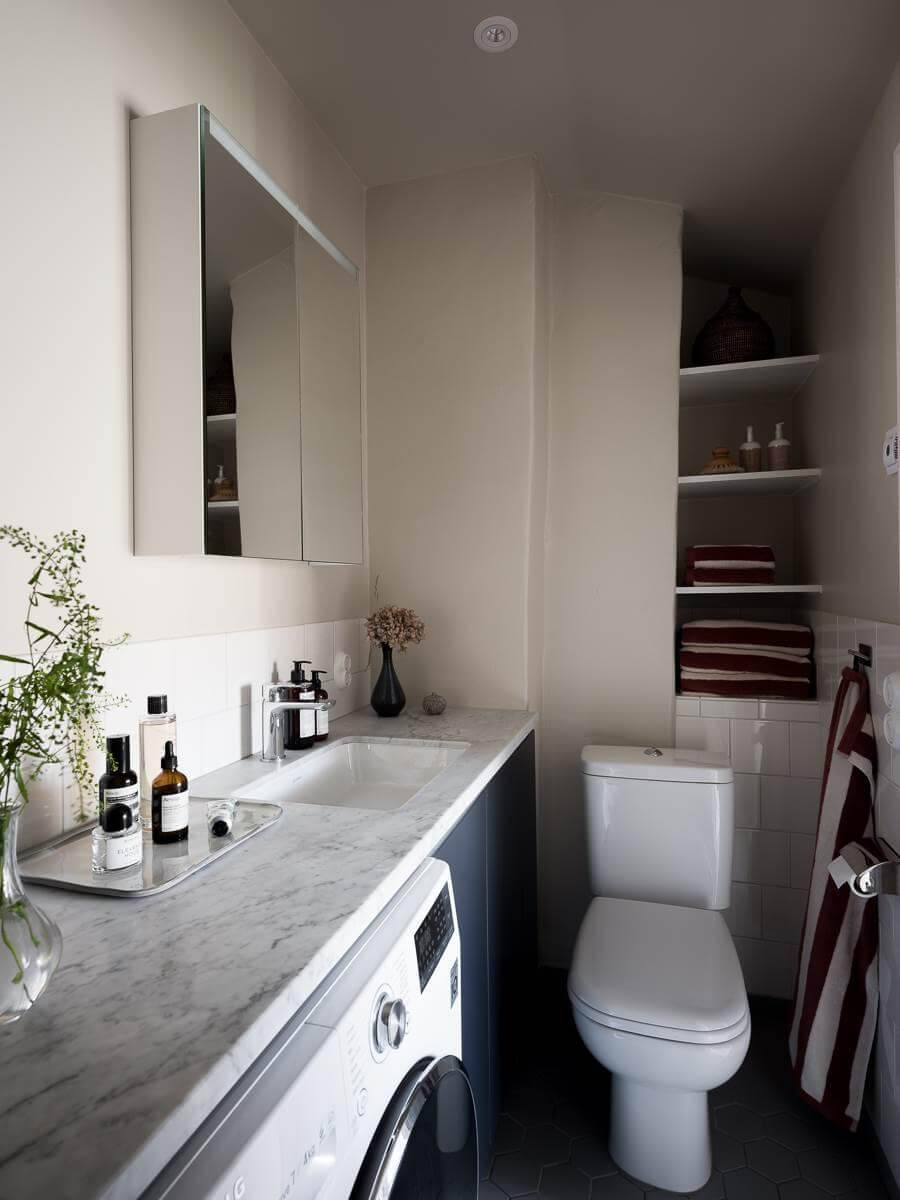 A Scandinavian Duplex That Blends Old and New 19 narrow-bathroom-storage-niches-marble-top-nordroom