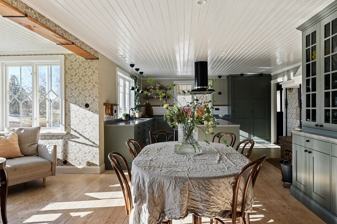 An Idyllic Family Home in the Swedish Countryside 2 open-plan-kitchen-dining-living-space-light-green-cabinets-nordroom