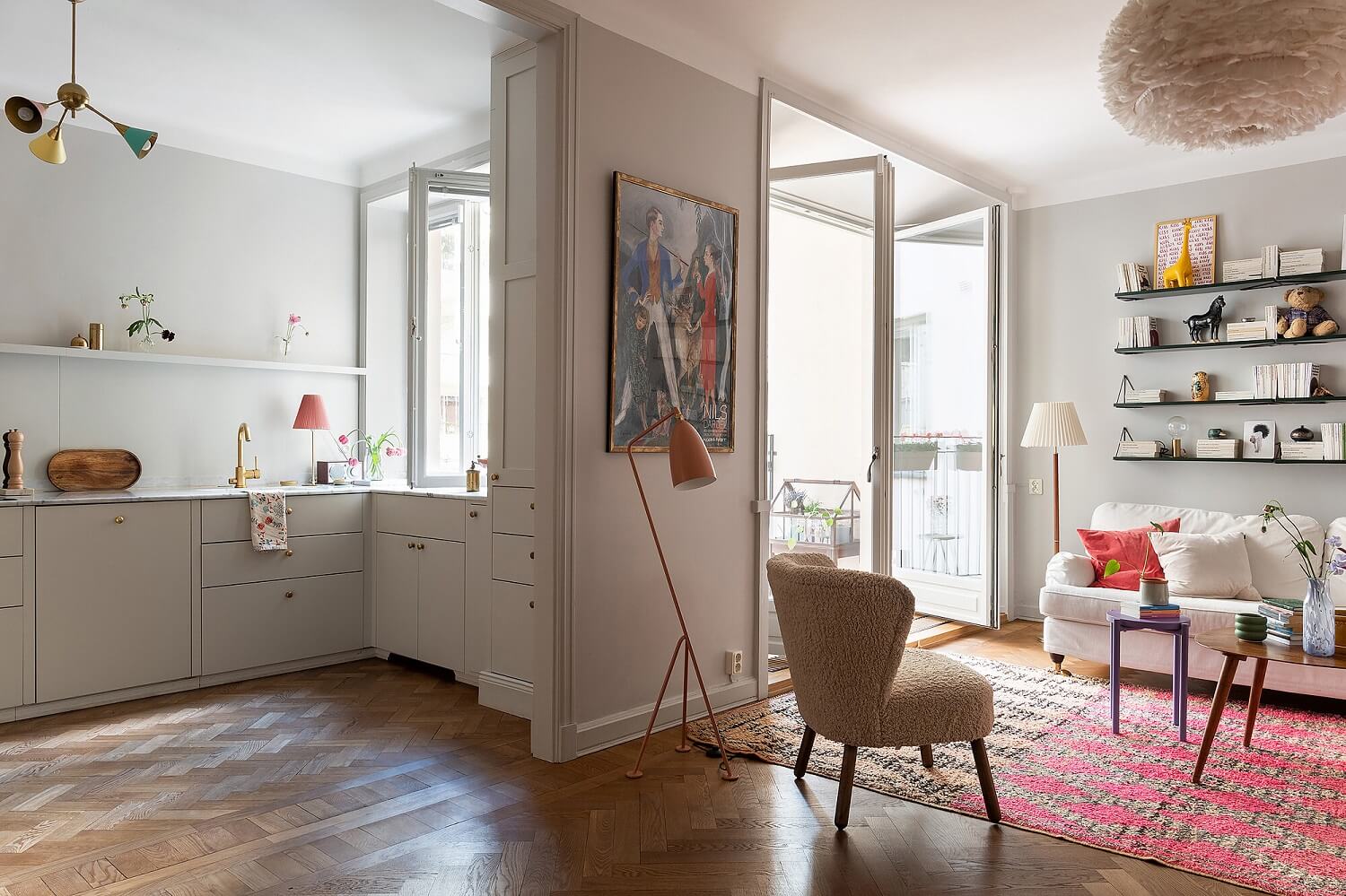 A Serene Nordic Apartment with Pink Color Accents 3 open-plan-living-room-kitchen-wooden-floorboards-pink-rug-nordroom