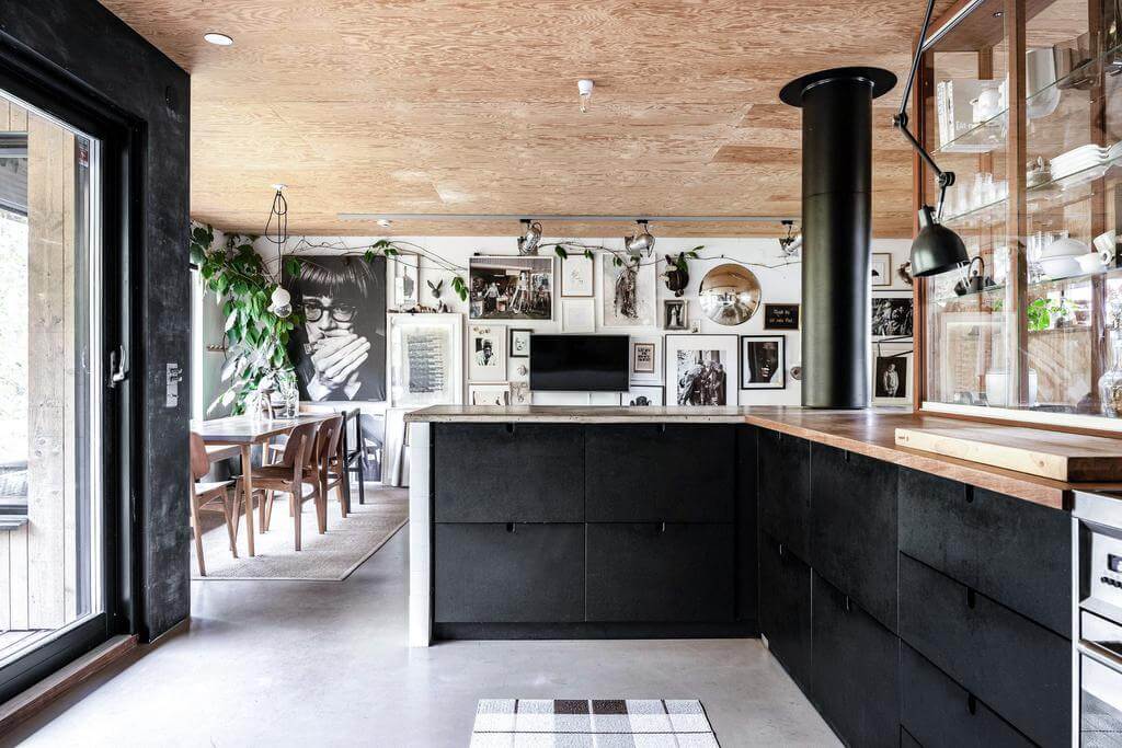 A Renovated Sustainable Home in Sweden 5 open-plan-living-space-kitchen-black-cabinets-nordroom