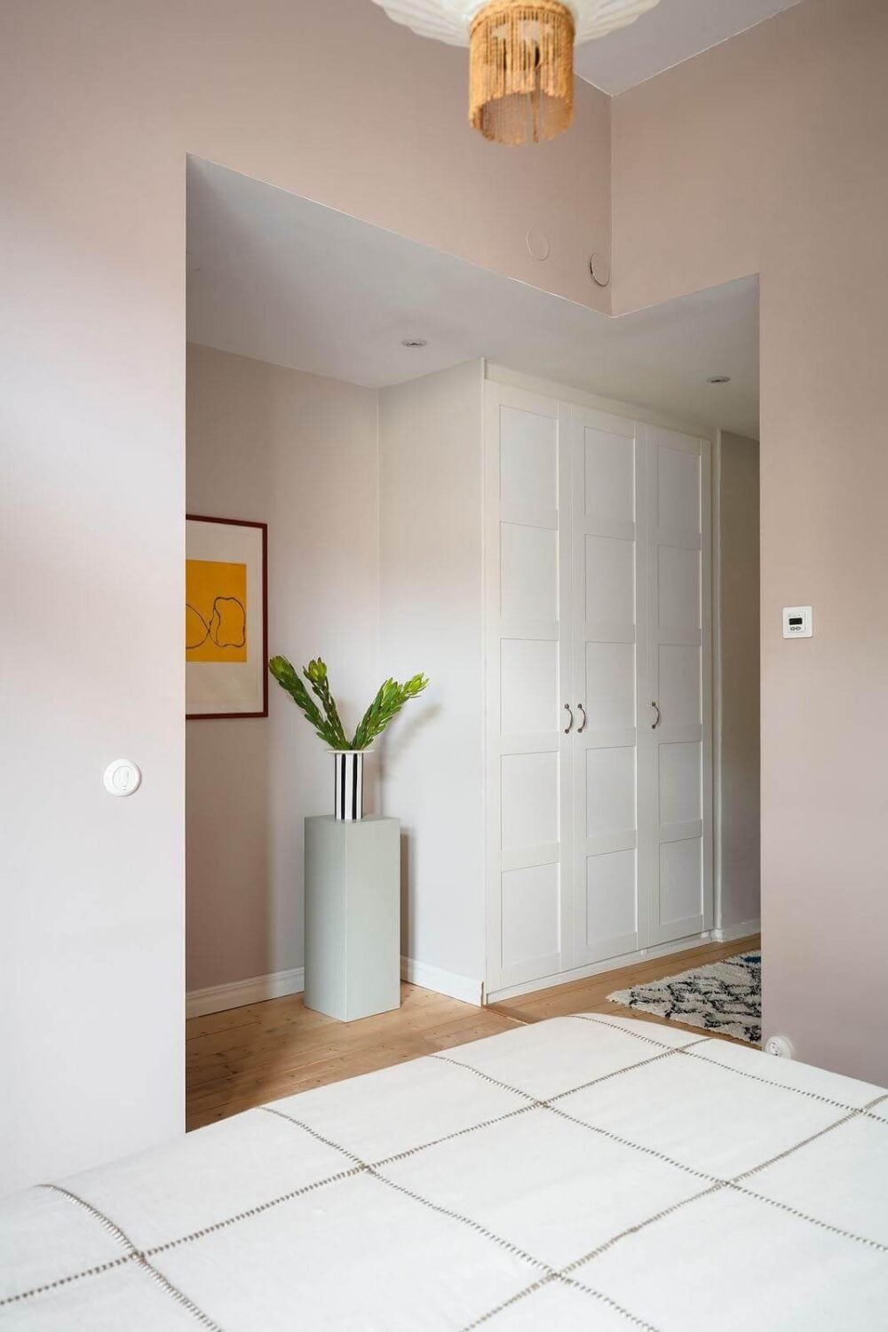 A Stylish Nordic Apartment with a Pink Bedroom 13 open-plan-pink-bedroom-wardrobes-nordroom
