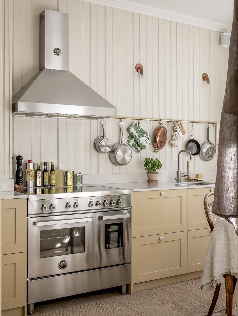 Glidden & PPG Color of the Year 2024: Limitless 25 pale-yellow-kitchen-cabinets-wooden-wall-nordroom
