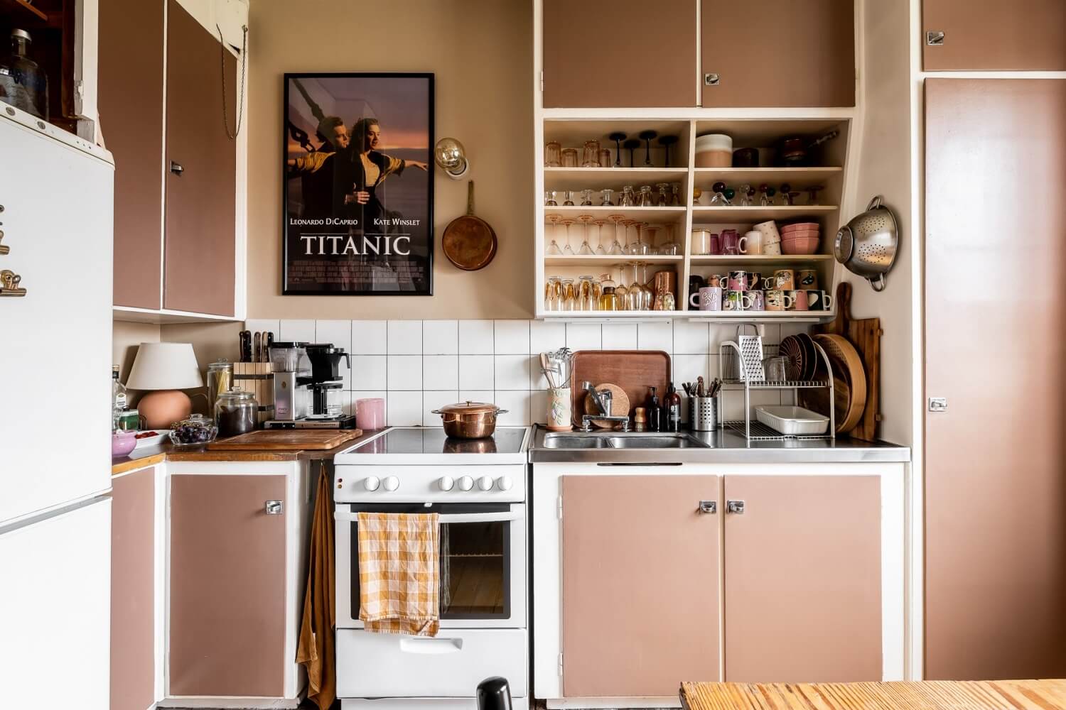 A Pink Studio Apartment with a Midcentury Kitchen 11 pink-kitchen-cabinets-midcentury-kitchen-nordroom