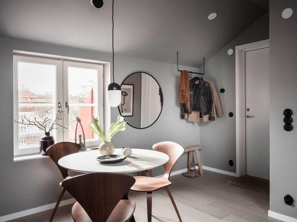 A Small Gray Attic Apartment in Sweden 9 round-dining-table-mirror-small-attic-apartment-nordroom