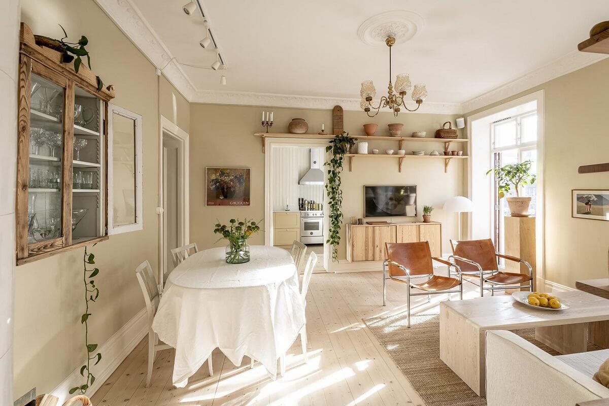 A Scandinavian Apartment with a Pale Yellow Kitchen 10 serene-living-room-beige-walls-wooden-floor-natural-light-nordroom