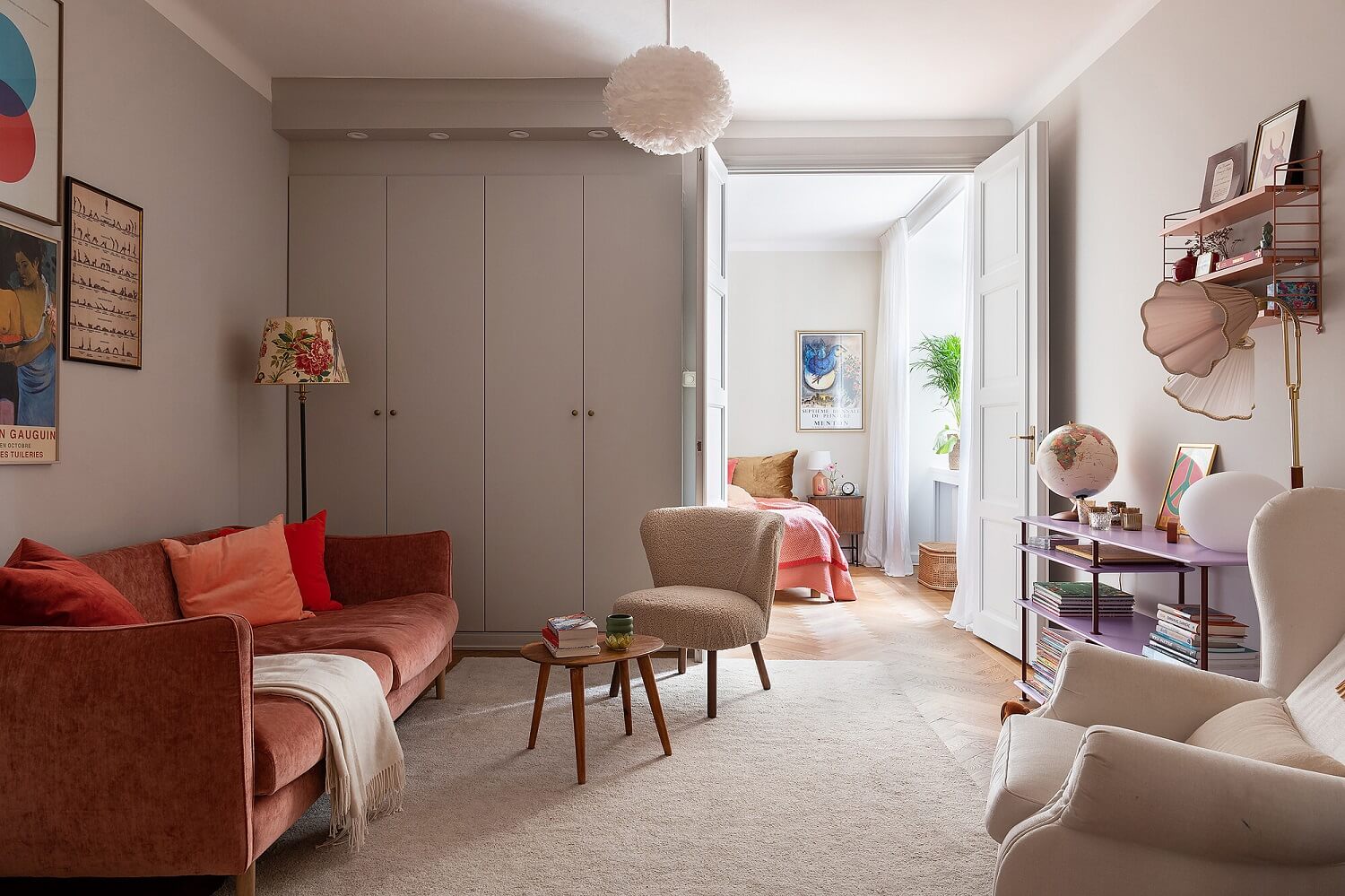 A Serene Nordic Apartment with Pink Color Accents 14 serene-living-room-gray-walls-cabinets-rusty-red-sofa-nordroom