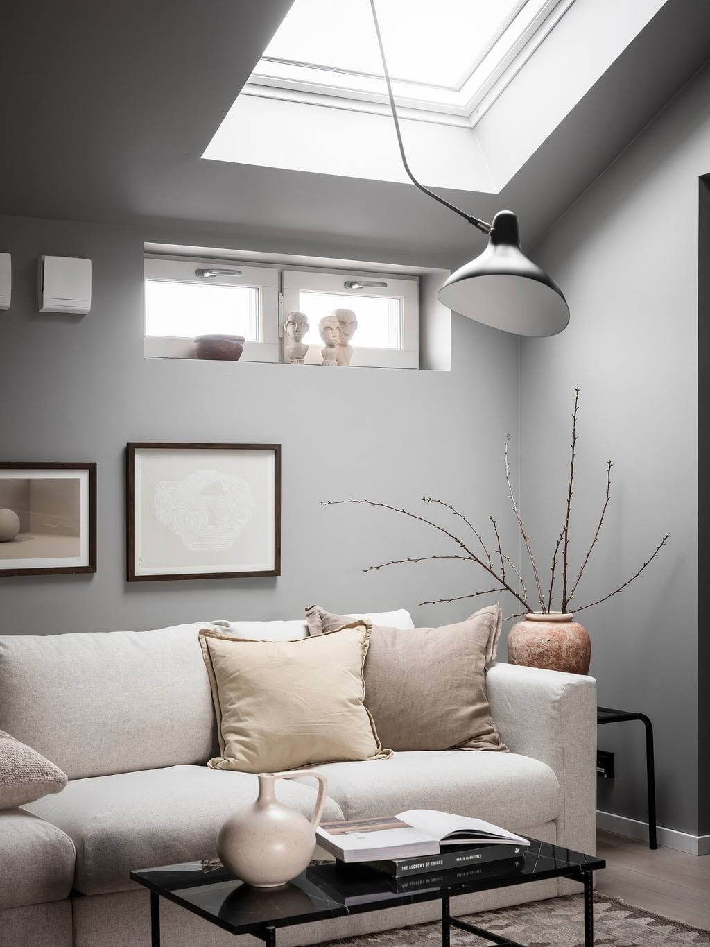 A Small Gray Attic Apartment in Sweden 3 sitting-room-slanted-ceiling-skylight-gray-walls-nordroom