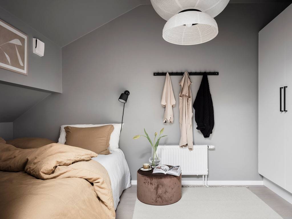 A Small Gray Attic Apartment in Sweden 12 small-gray-bedroom-slanted-ceiling-built-in-wardrobes-nordroom