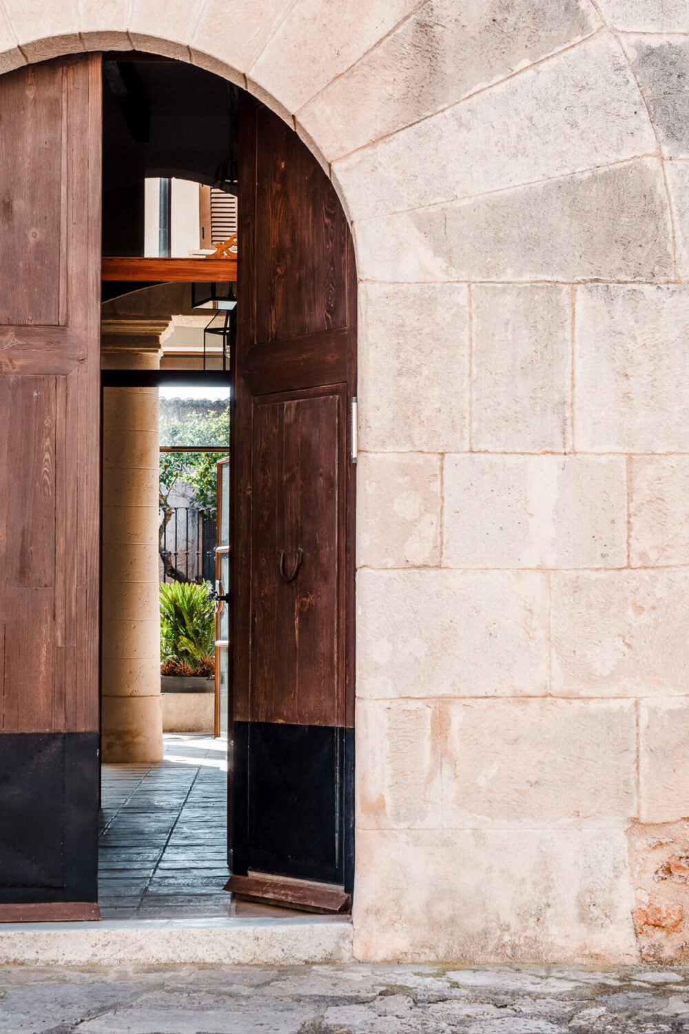 A Renovated Historic Townhouse on Mallorca 2 arched-doorway-wooden-doors-historic-townhouse-mallorca-nordroom