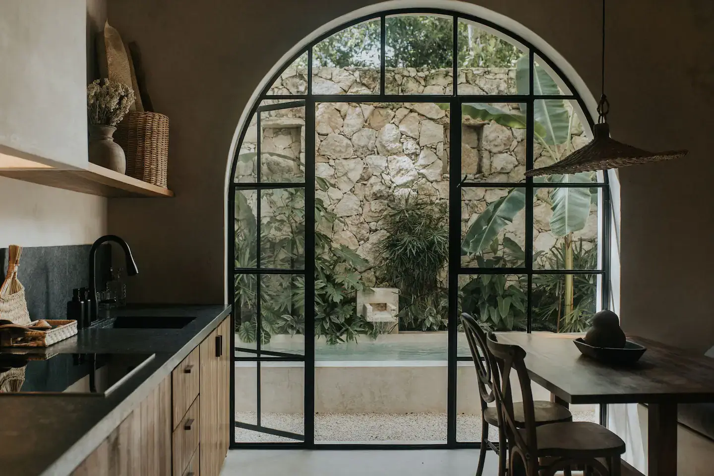 Rustic Wooden Elements in a Stylish Tulum Airbnb 15 arched-glass-steel-windows-doors-patio-garden-nordroom