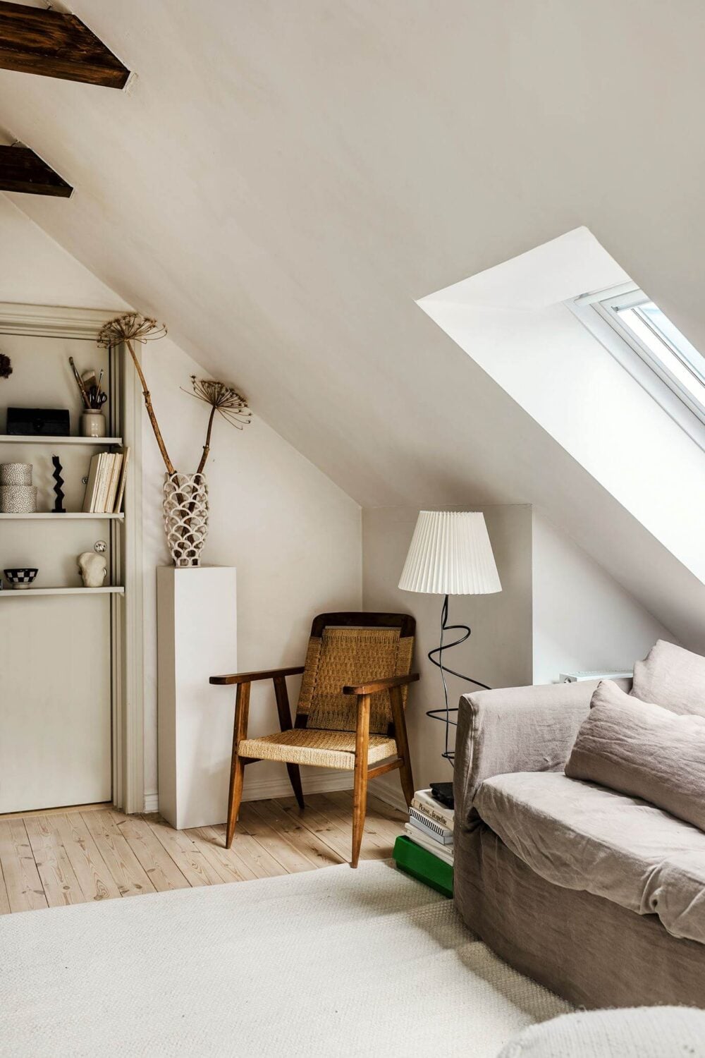 A Charming Attic Apartment with High Ceilings 12 attic-apartment-sitting-room-gray-couch-nordroom