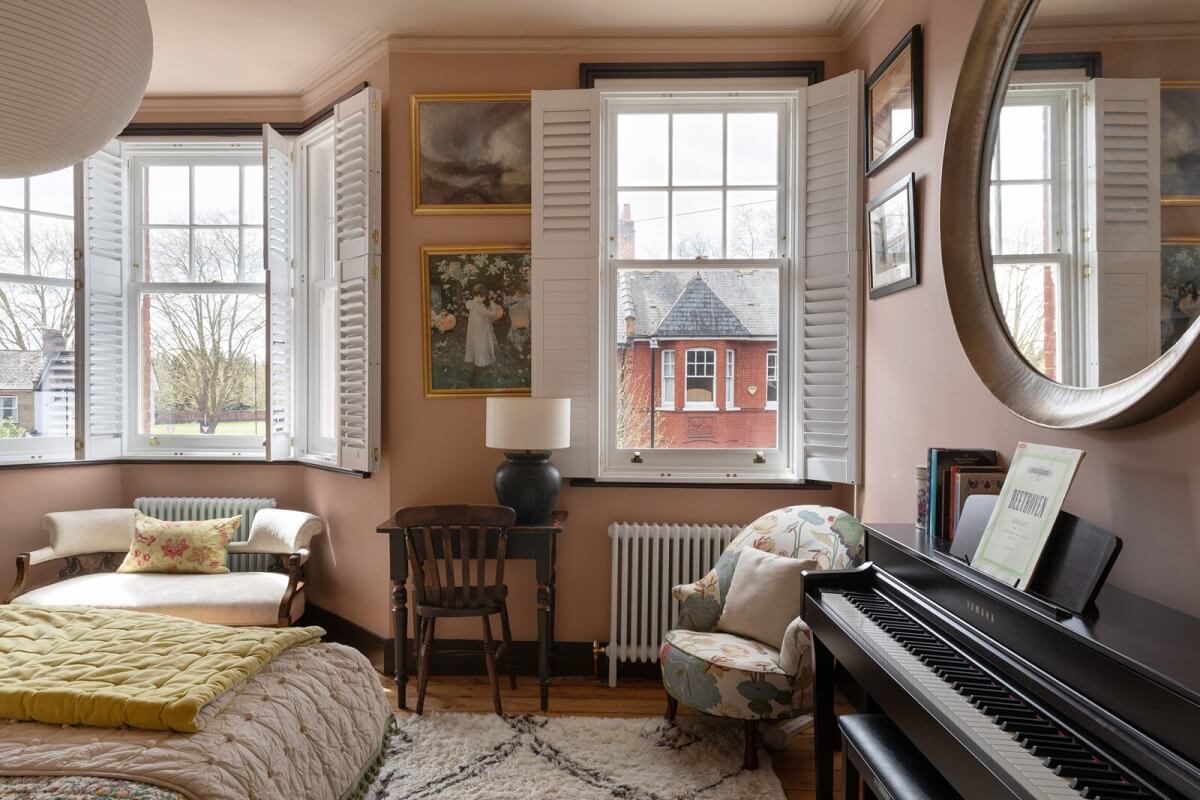 Colorful Rooms in a Family Home in London 12 bedroom-bay-window-plaster-pink-walls-wooden-floorboards-nordroom