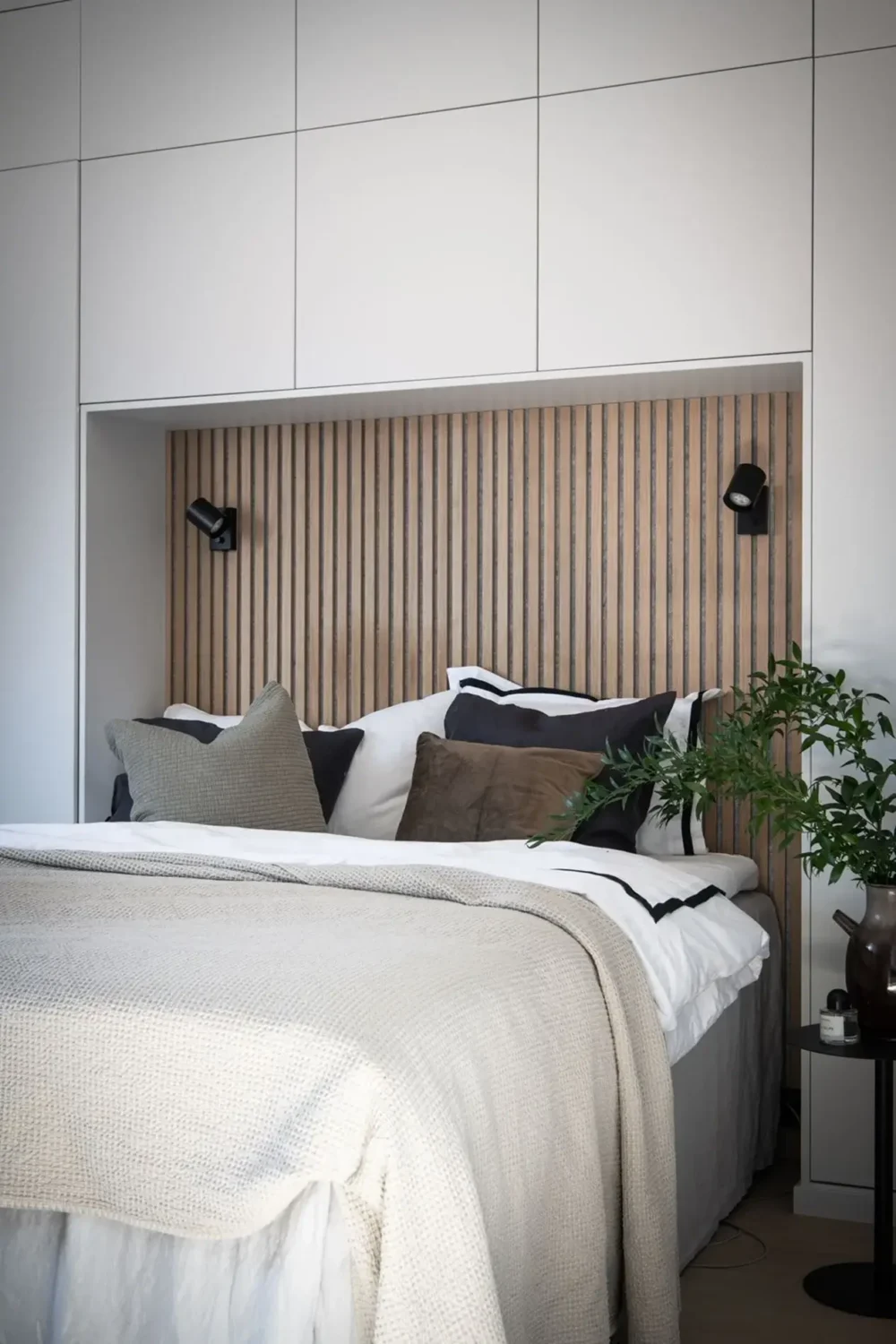 A Stylish Scandinavian Attic Apartment 12 bedroom-built-in-closets-wooden-accent-wall-nordroom