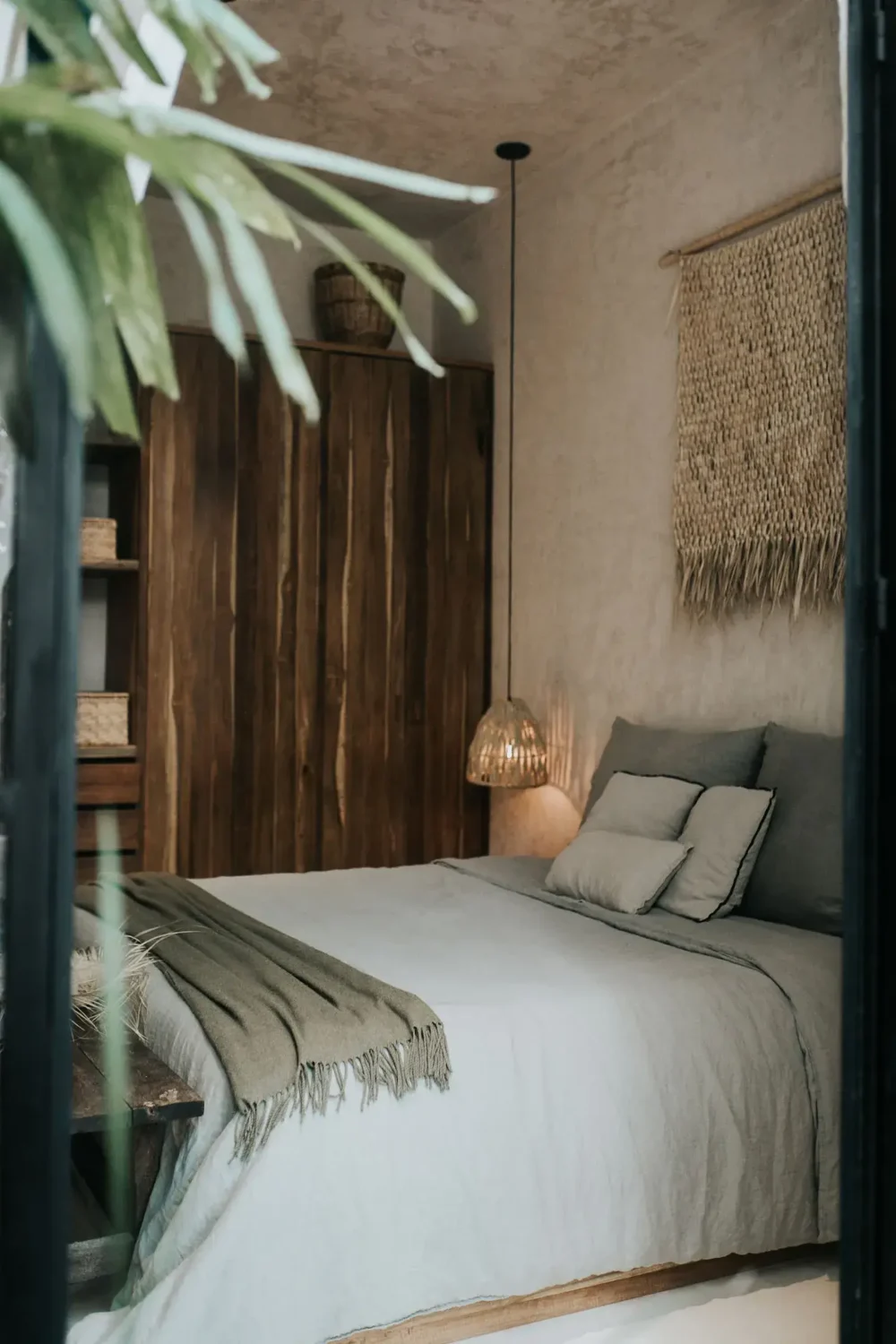 Rustic Wooden Elements in a Stylish Tulum Airbnb 17 bedroom-gray-blue-bedding-rustic-wooden-wardrobe-nordroom