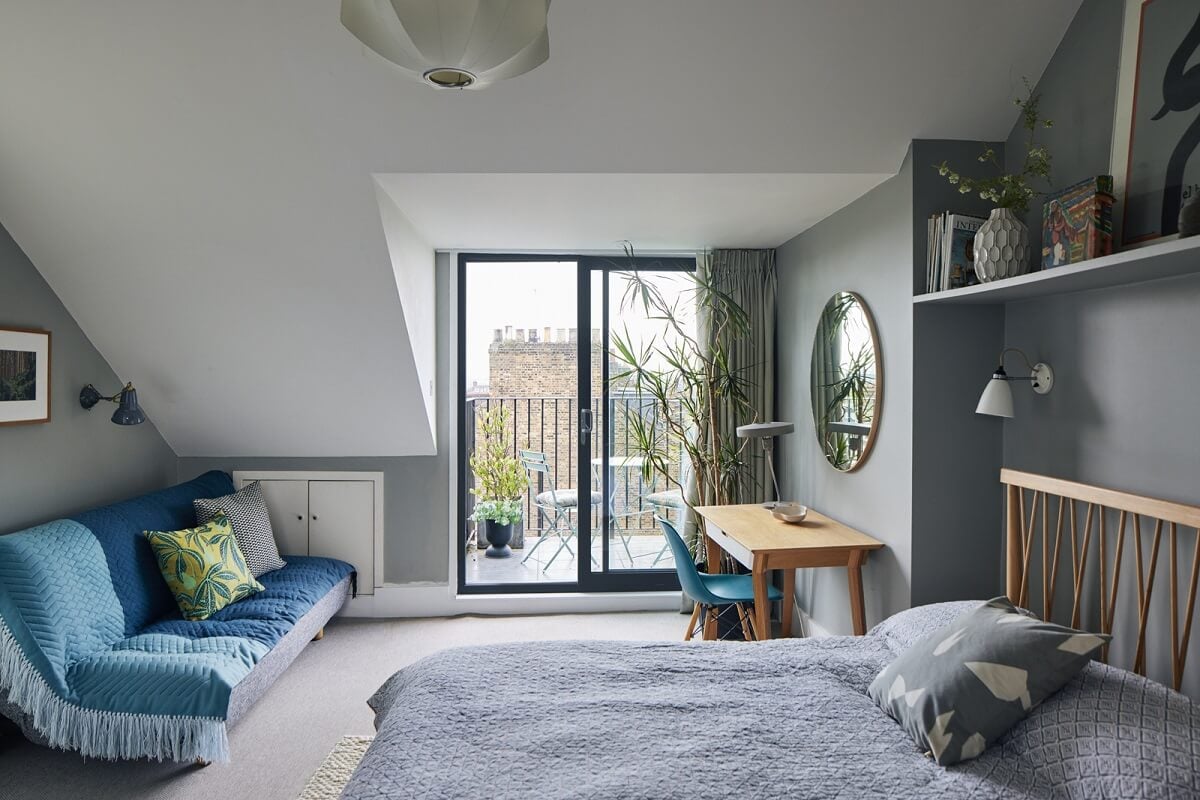 A Light Victorian Townhouse with Teal Reading Room 19 bedroom-slanted-ceiling-balcony-gray-walls-shelf-above-bed-nordroom
