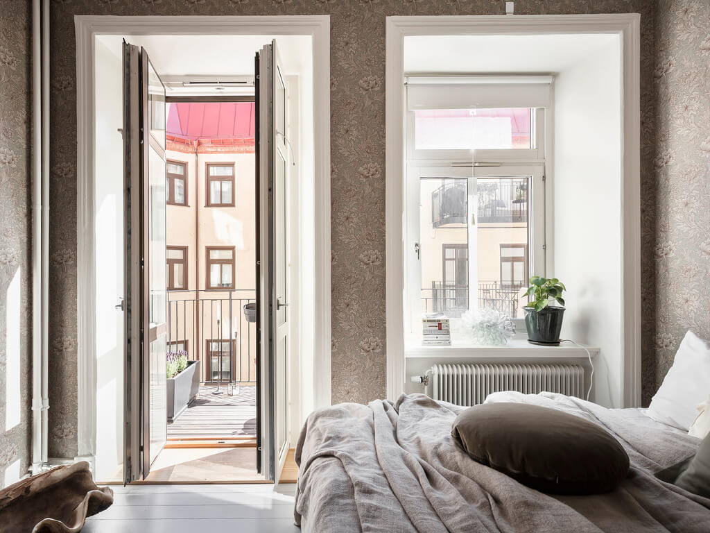 A Scandi Home with Stainless Steel Kitchen and Wallpaper 27 bedroom-with-balcony-brown-wallpaper-nordroom