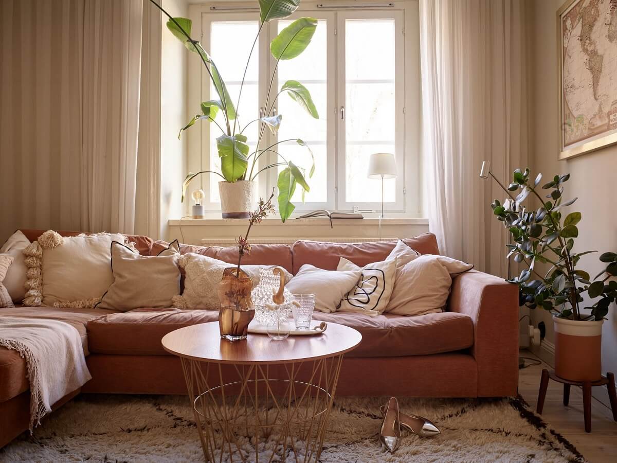 Warm Muted Colors in a Stockholm Apartment 3 beige-apartment-orange-red-sofa-cushions-nordroom