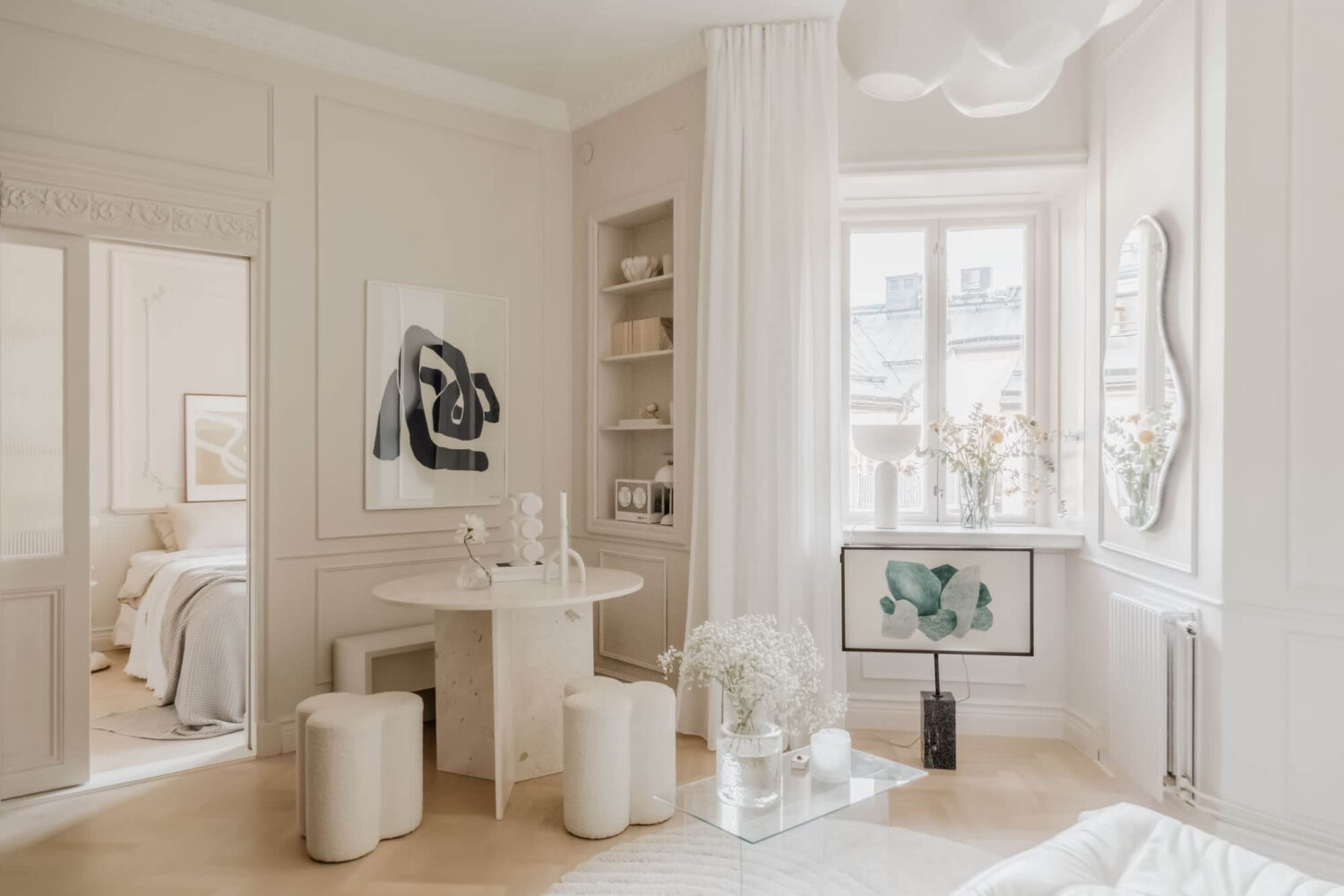 beige-living-room-small-round-dining-table-built-in-bookshelfs-nordroom