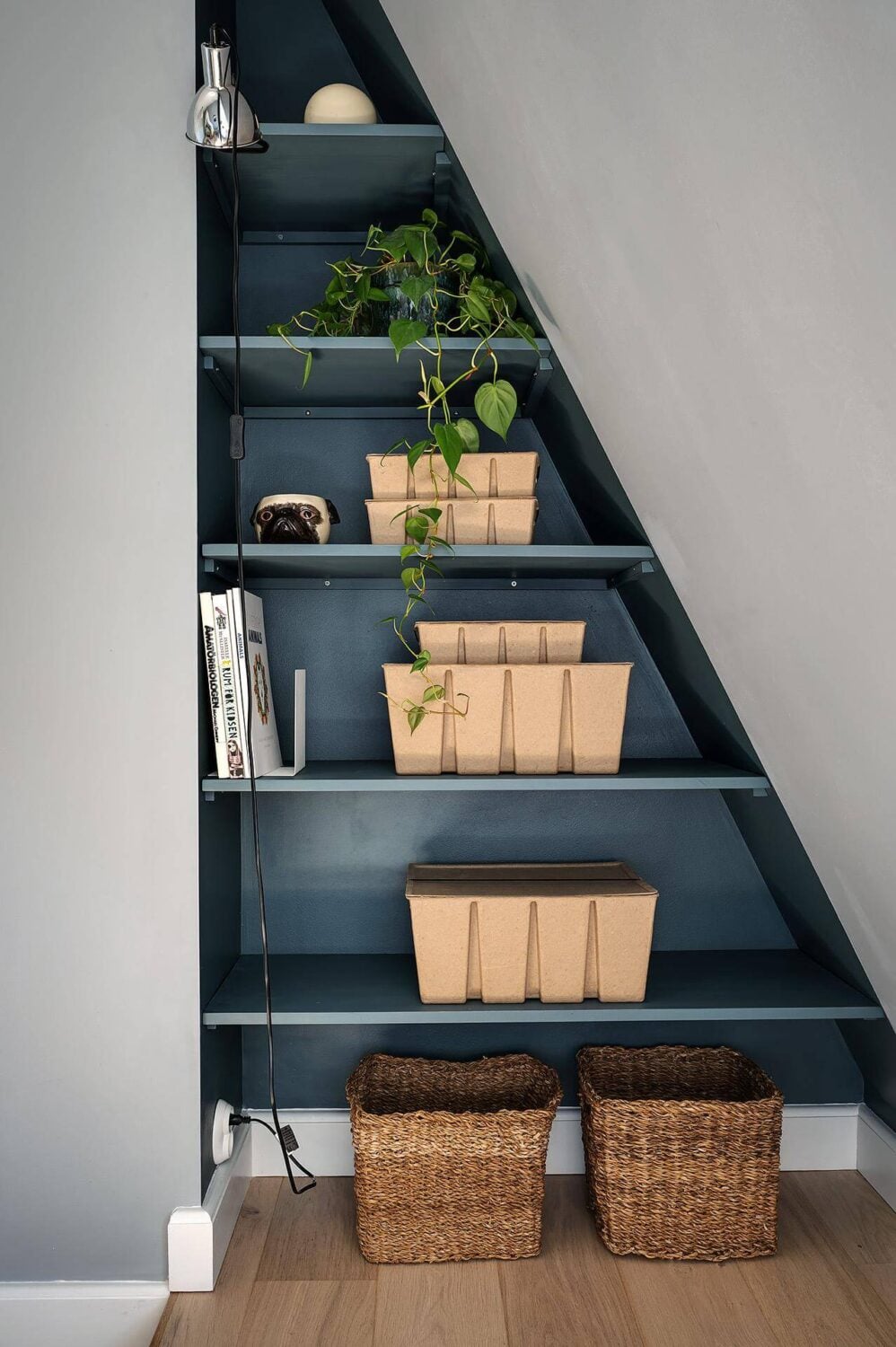 A Modern Scandinavian Attic Apartment 22 blue-painted-built-in-shelves-slanted-ceiling-nordroom