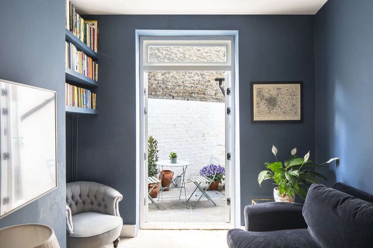 Benjamin Moore Color of the Year 2024: Blue Nova 24 blue-sitting-room-bookshelves-patio-access-nordroom