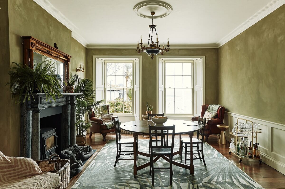 A Georgian Townhouse with Views of the Falmouth Harbour 1 dining-room-green-walls-round-table-large-rug-fireplace-nordroom
