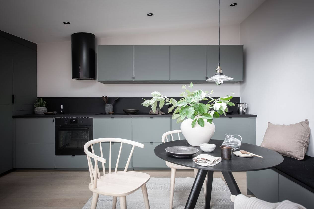 A Stylish Scandinavian Attic Apartment 7 green-scandinavian-kitchen-bench-round-dining-table-nordroom
