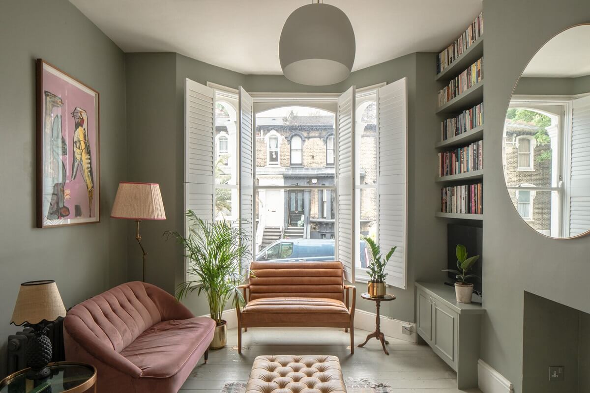 Muted Natural Colors in a Victorian House 1 green-sitting-room-bay-window-bookshelves-round-mirror-nordroom