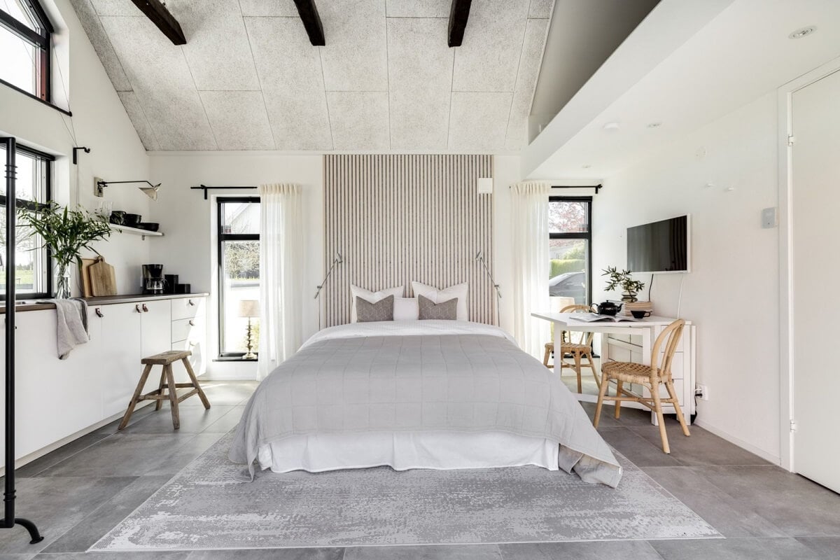 A Monochrome Swedish Villa with High Ceilings 33 guest-house-light-gray-white-bed-kitchen-nordroom