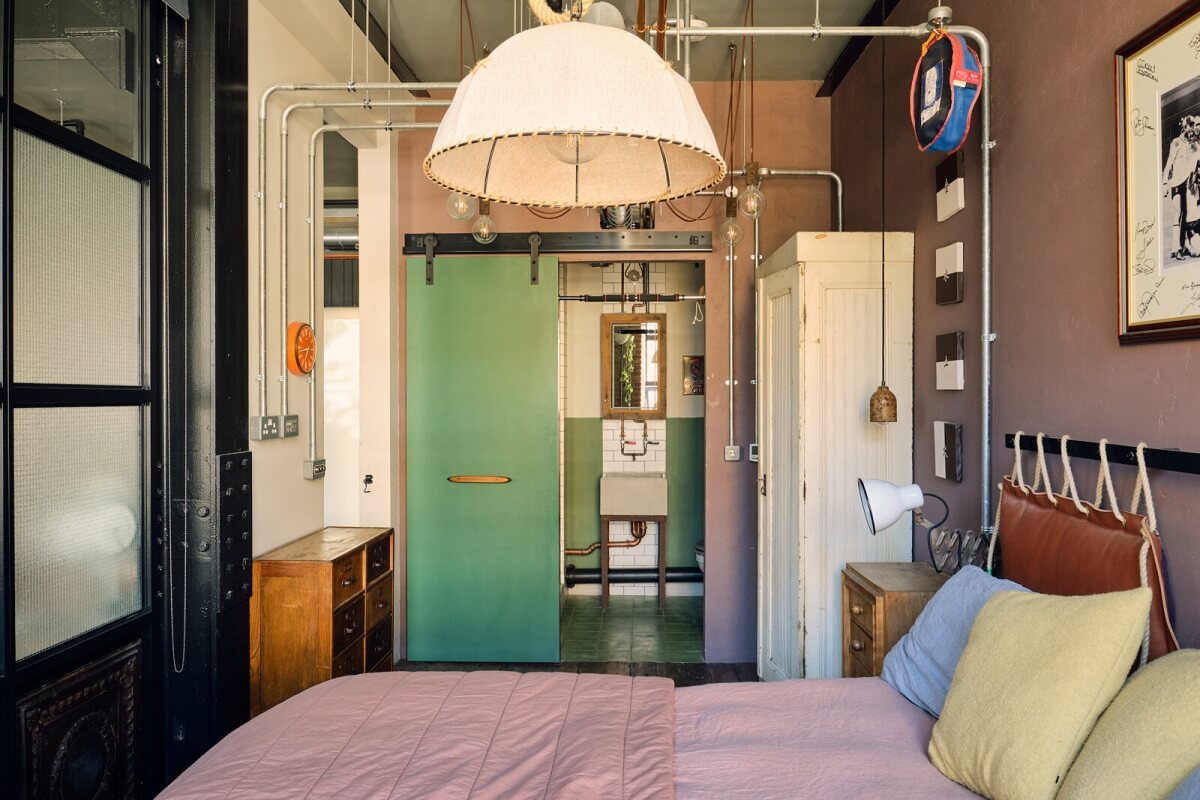 An Industrial Warehouse Apartment in London 14 industrial-master-bedroom-en-suite-bathroom-green-sliding-door-nordroom