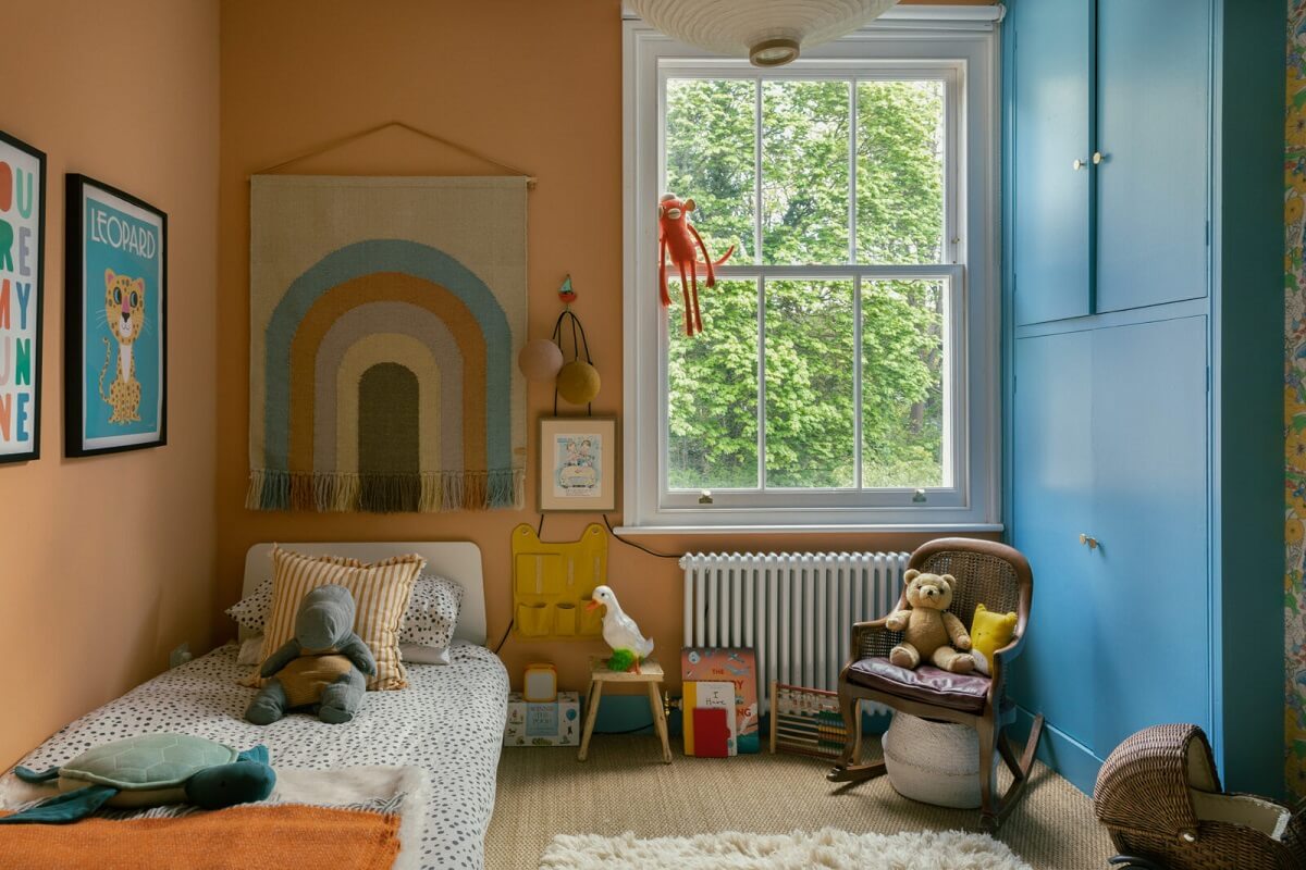 Colorful Rooms in a Family Home in London 17 kids-bedroom-salmon-pink-walls-blue-wardrobe-nordroom