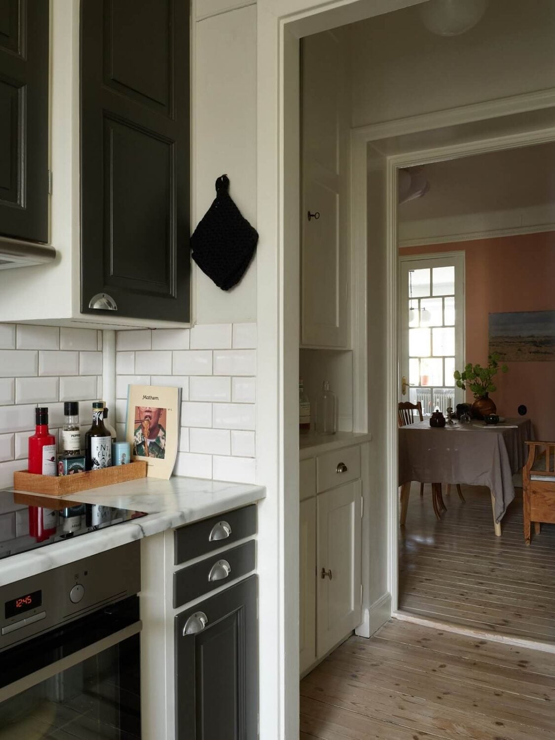 A Scandinavian Apartment with a Light Green Bedroom 14 kitchen-dark-grey-cabinets-wooden-floor-nordroom