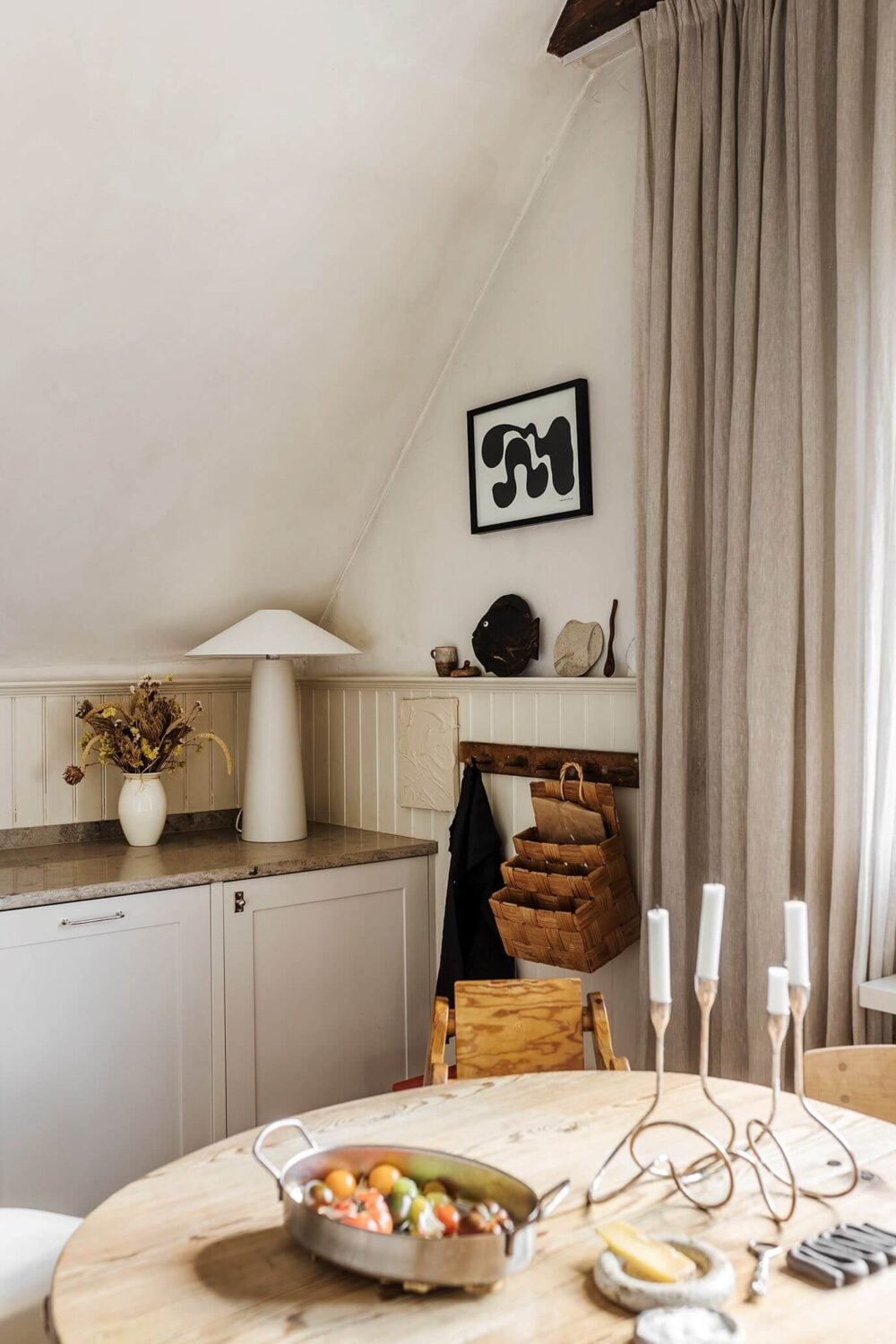A Charming Attic Apartment with High Ceilings 4 kitchen-round-wooden-dining-table-nordroom