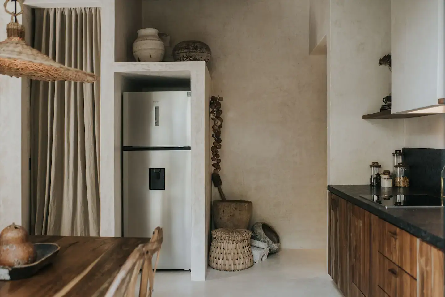 Rustic Wooden Elements in a Stylish Tulum Airbnb 16 kitchen-rustic-wooden-cabinets-niche-fridge-nordroom
