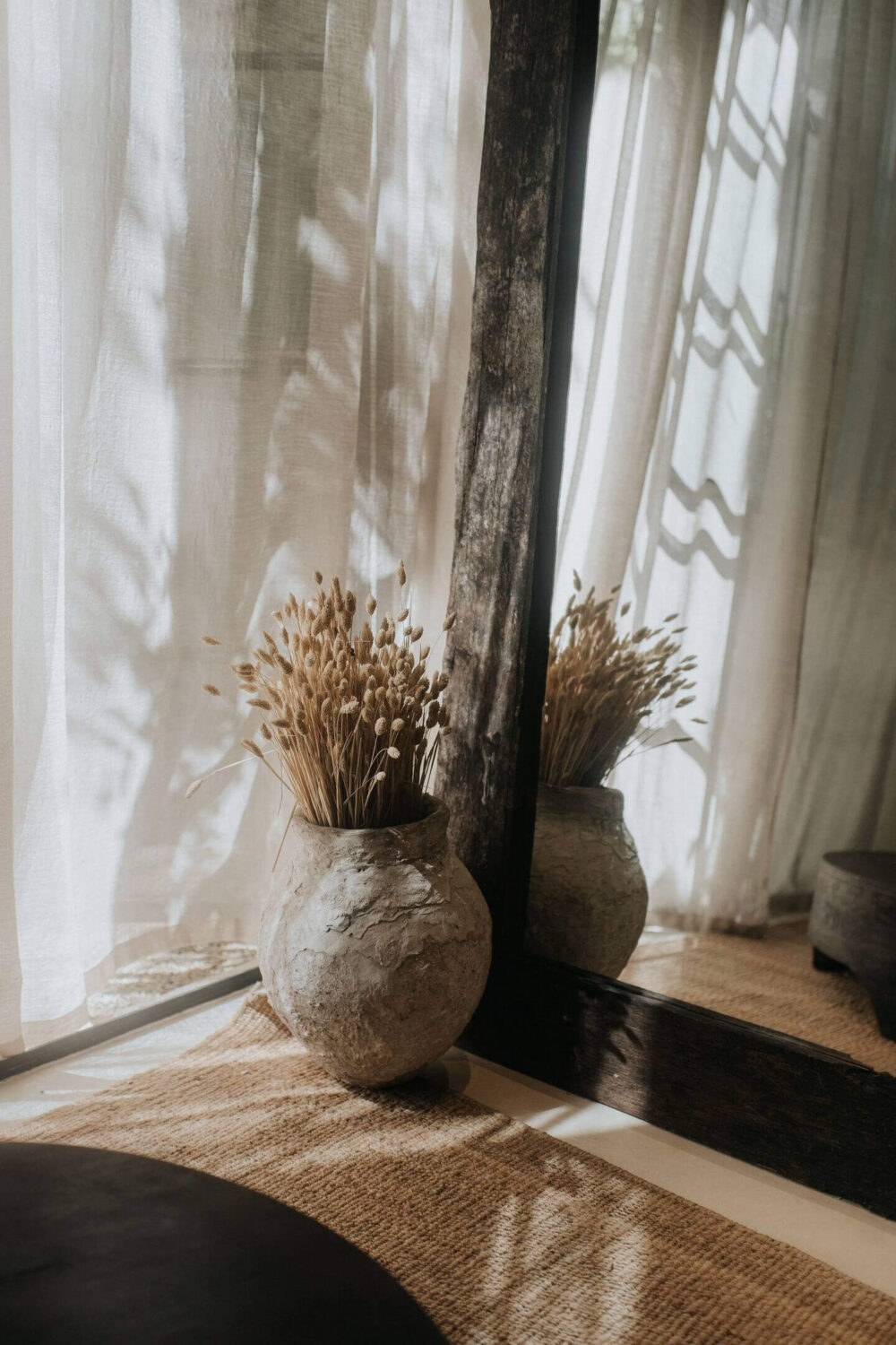 Rustic Wooden Elements in a Stylish Tulum Airbnb 10 living-room-detail-large-wooden-mirror-stone-vase-nordroom