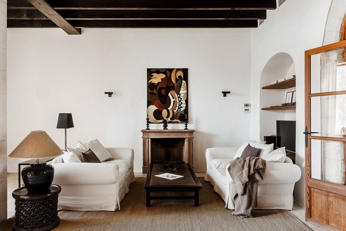 A Renovated Historic Townhouse on Mallorca 5 living-room-exposed-wooden-beams-white-sofas-arched-niche-nordroom