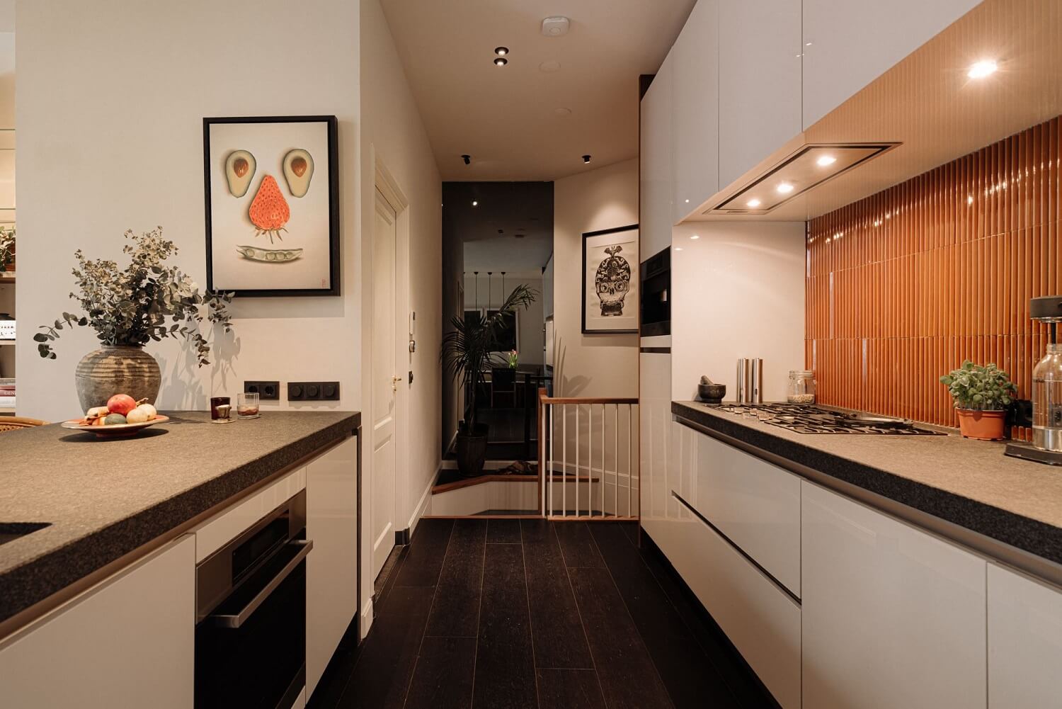 A Luxurious Duplex Apartment in Amsterdam 9 modern-galley-kitchen-white-cabients-textured-orange-backsplash-nordroom